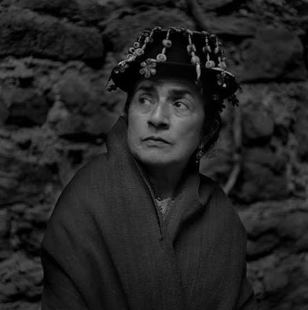Black-and-white portrait of Carmita Vicente in a beaded hat and shawl